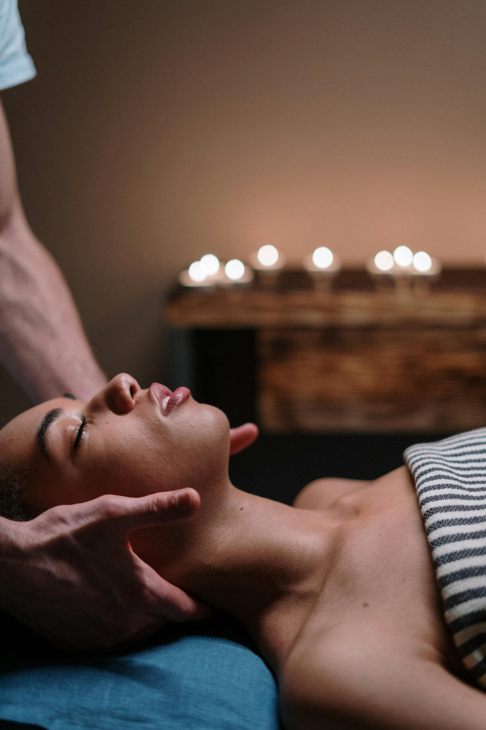 About A woman enjoying a relaxing face massage in a tranquil spa setting.